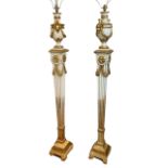 A PAIR OF EARLY 20TH CENTURY GILTWOOD AND CREAM STANDARD LAMPS Figured with rams heads swags and