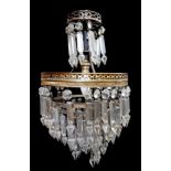 A 19TH CENTURY GILT METAL AND CRYSTAL GLASS THREE GRADUATED TIER CHANDELIER Hung with tear and prism