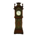 AN EARLY 20TH CENTURY NOVELTY CONTINENTAL OAK CASED DESK CLOCK FASHIONED AS A LONGCASE VICTORIAN