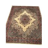 A LARGE VINTAGE AXMINSTER PERSIAN DESIGN RUG OF CARPET PROPORTIONS The central floral lozenge