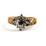 A VINTAGE 18CT GOLD, DIAMOND AND SAPPHIRE RING The single round cut sapphire edged with a diamond
