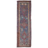 A TURKISH WOOL KILIM RUNNER The central field having geometric forms to central field on blue ground