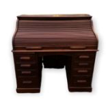 AN EARLY 20TH CENTURY OAK TAMBOUR DESK The 'S' shaped folding front, enclosing a fitted interior