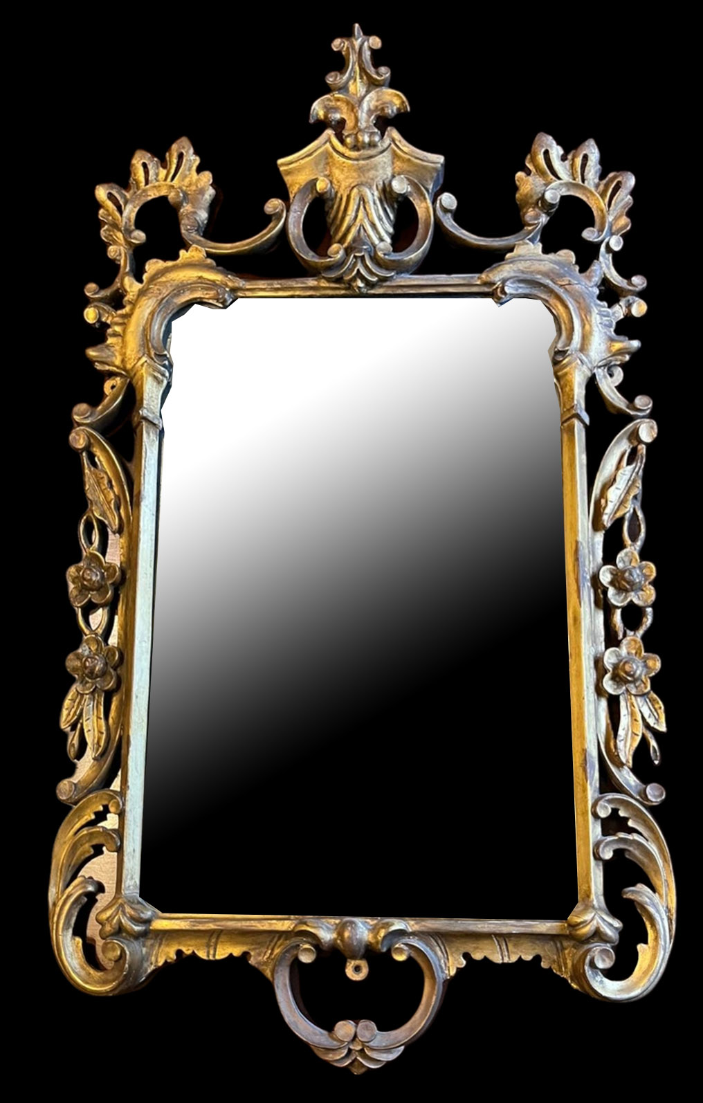 A 19TH CENTURY ITALIAN GILTWOOD FRAMED MIRROR The carved and pierced frame crested with a