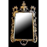 A 19TH CENTURY ITALIAN GILTWOOD FRAMED MIRROR The carved and pierced frame crested with a