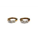 A VINTAGE PAIR OF 9CT GOLD AND DIAMOND EARRINGS Each set with three diamond clusters on a plain hoop