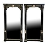A PAIR OF 19TH CENTURY EBONISED AND BRASS INLAID MIRRORS Set with porcelain plaques decorated with