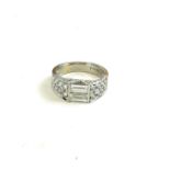 BEYER, A PLATINUM BAGUETTE AND BRILLIANT CUT DIAMOND RING, two baguette cut stones flaked by