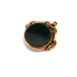 A VICTORIAN 9CT ROSE GOLD AND HARDSTONE CIRCULAR SWIVEL FOB On a hinged mount. (approx overall