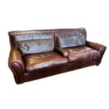 FENDI, A TAN LEATHER UPHOLSTERED THREE SEATER SETTEE Complete with loose cushions, bearing brand