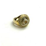 AN 18CT GOLD, DIAMOND, CITRINE AND QUARTZ CLUSTER RING The single round cut citrine edged with