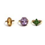 A COLLECTION OF THREE VINTAGE 9CT GOLD AND GEM SET RINGS To include an oval citrine, an emerald