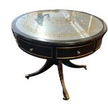 IN THE MANNER OF VERSACE, AN EBONISED AND PARCEL GILT DRUM TABLE The Greek Key and floral gilt