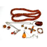 A COLLECTION VINTAGE AMBER JEWELLERY To include a necklace with carved faceted links, two silver and