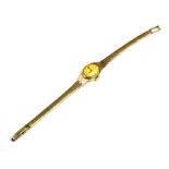 ACCURIST, A VINTAGE 9CT GOLD LADIES' WRISTWATCH The oval gold tone dial marked 'Accurist', on an