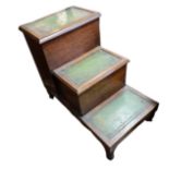 A SET OF 19TH CENTURY MAHOGANY STEPS With green tooled leather rise and fall treads, raised on