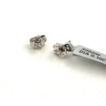 A PAIR OF 20TH CENTURY SILVER AND DIAMOND STUD EARRINGS Each set with a single round cut diamond. (