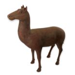 A LARGE TANG STYLE UNGLAZED POTTERY FIGURE OF A DEER. (h 47cm x length 46cm)
