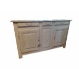 A 19TH CENTURY FRENCH DRESSER With three drawers above panelled cupboards, in a distressed cream
