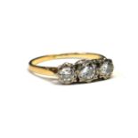 AN EARLY 20TH CENTURY 18CT GOLD AND DIAMOND THREE STONE RING Graduated stones in an illusion set