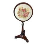 A REGENCY MAHOGANY TELESCOPIC POLE SCREEN The circular floral silk panel supported on an