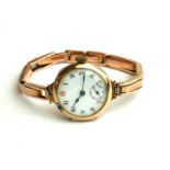 RED TWELVE, AN ART DECO 9CT GOLD LADIES' GOLD WRISTWATCH The circular white dial with seconds