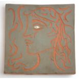 PABLO PICASSO, A RED TERRACOTTA TILE The centre hand carved with scraffito technique depicting