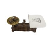 A SET OF VICTORIAN IRON WEIGHING SCALES Having a heavy bronze bowl and a decorated white enamelled