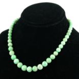 A GRADUATED JADE STONE NECKLACE Fastened with a 9ct gold clasp.