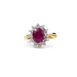 AN 9CT YELLOW GOLD OVAL RUBY AND DIAMOND CLUSTER RING. (Ruby 1.86ct, Diamonds 0.06ct)