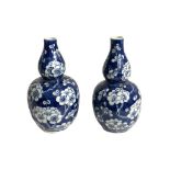 A PAIR OF 19TH CENTURY CHINESE BLUE AND WHITE DOUBLE GOURD POSY VASES Bearing a four character