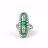 A FINE QUALITY PLATINUM ELONGATED OVAL SHAPED DRESS RING set with emeralds and diamonds. (Emeralds
