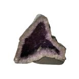 A LARGE DECORATIVE AMETHYST CRYSTAL GEODE. (h 46cm x d 22cm x w 51cm)