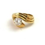 A 14CT GOLD AND DIAMOND SOLITAIRE RING, A single round cut diamond in a half twist mount. Size I,