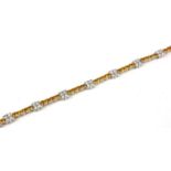 18CT WHITE GOLD YELLOW SAPPHIRE AND DIAMOND LINE BRACELET. Sapphires 4.57ct. Diamonds 1.82ct