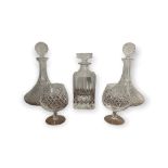 A PAIR OF MOULDED GLASS SHIPS DECANTERS diamond cut design along with a pair of brandy glasses and