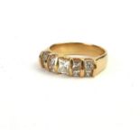 A 14CT GOLD AND DIAMOND CLUSTER RING, The central princess cut diamond flanked with two pairs of
