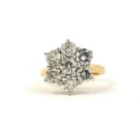 AN 18CT WHITE AND YELLOW GOLD 7 STONE DAISY STYLE DIAMOND CLUSTER RING. (Diamonds 2.91ct) With