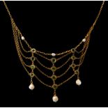 A VICTORIAN YELLOW METAL PERIDOT AND PEARL LACE NECKLACE, yellow metal tested as 22ct gold. Gross