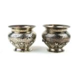 HOLLAND, ALDWINCKLE & SLATER, LONDON, A PAIR OF ARTS & CRAFTS PLANISHED SILVER SALTS, CIRCA 1902. (