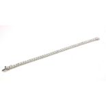 AN 18CT WHITE GOLD ROUND BRILLIANT CUT DIAMOND LINE BRACELET. (Diamonds 8.20ct) Boxed.