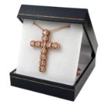 A 9CT ROSE GOLD CROSS, SET WITH ROUND BRILLIANT CUT DIAMONDS on a 9ct rose gold chain. (Diamonds 3.