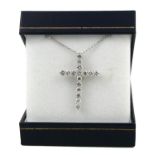 AN 18CT WHITE GOLD CROSS, SET WITH ROUND BRILLIANT CUT DIAMONDS on an 18ct white gold chain. (