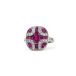 A PLATINUM ART DECO STYLE RING set with rubies and diamonds.