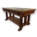 A 19TH CENTURY OAK GOTHIC REVIVAL TWO DRAWER FREESTANDING LIBRARY TABLE the shaped tooled leather