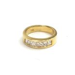 A 14CT GOLD AND DIAMOND HALF ETERNITY RING, set with six graduated princess cut diamonds. Approx 0.