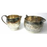 AN EARLY 20TH CENTURY AMERICAN STERLING SILVER SUGAR BASIN AND CREAM JUG With embossed scene of