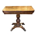 A 19TH CENTURY MAHOGANY FOLD OVER TEA TABLE Raised on carved bulbous column and platform base,