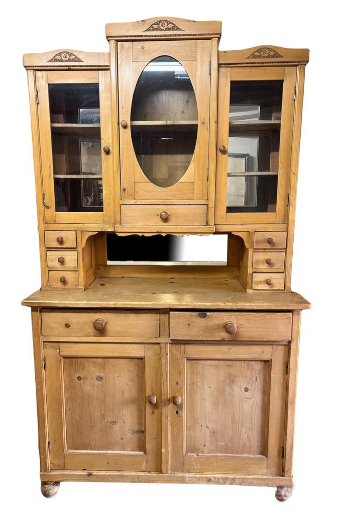 A 19TH CENTURY CONTINENTAL PINE DRESSER With three glazed doors above an arrangement of drawers