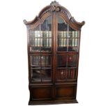 AN EARLY 20TH CENTURY DUTCH OAK DOMED TOPPED DISPLAY CABINET With shell cartouche above two glazed